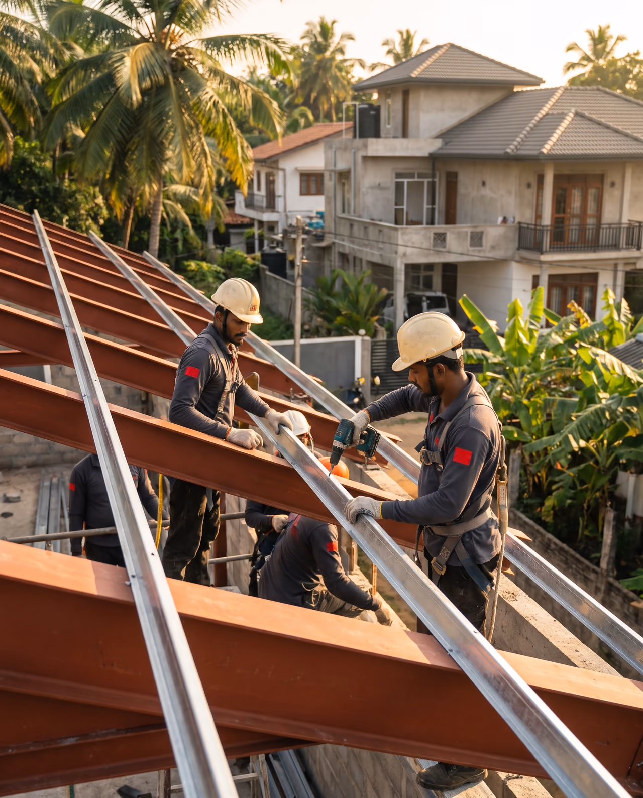 Installers bolting galvanised C purlins to steel rafters on a warehouse roof frame in Sri Lanka